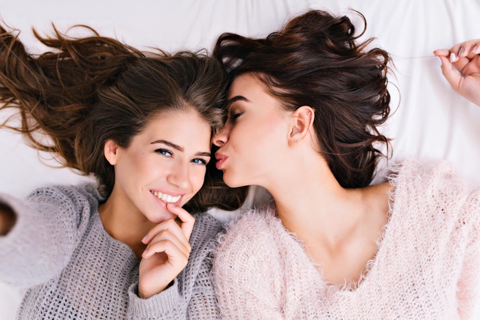 Two women are establishing an intimate relationship