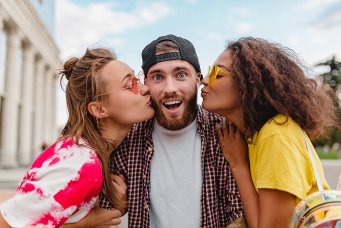 Three people in a poly unicorn relationship
